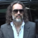 Sobbing activist says Russell Brand stripped to his ‘budgie smugglers’ and pushed her down on a hotel bed